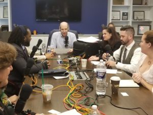 podcast participants sitting at a long table