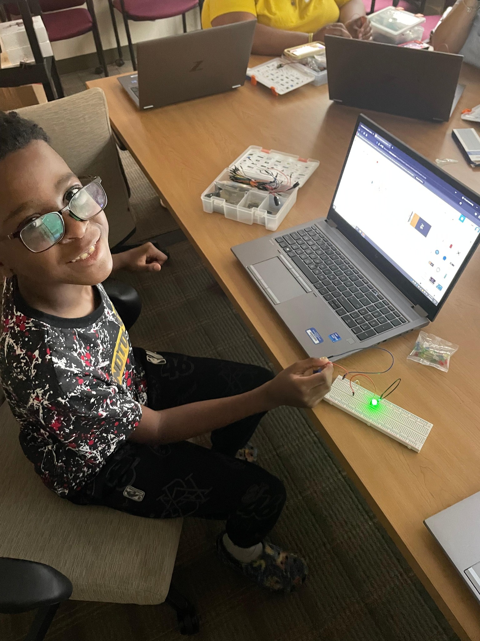 Kid looking up from computer