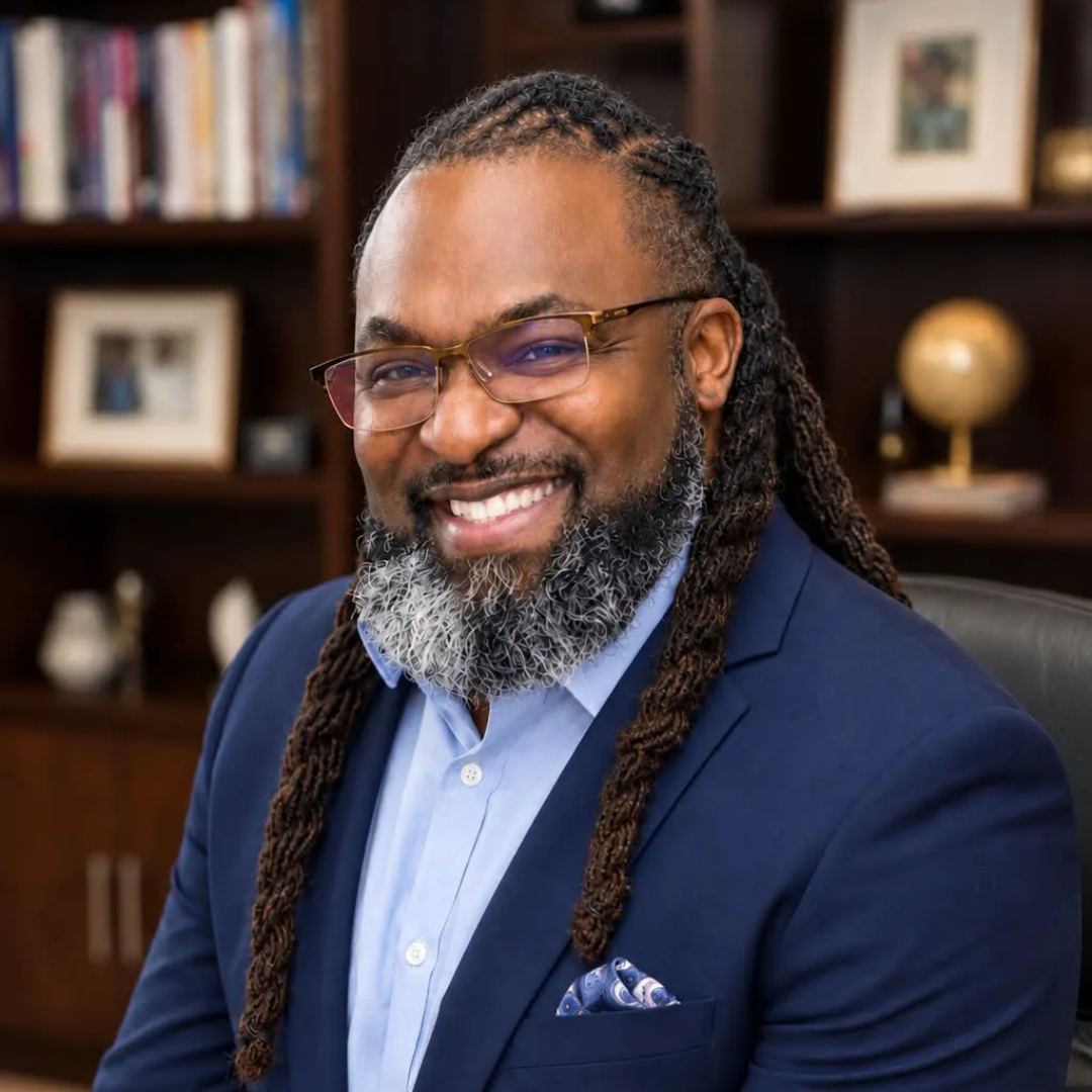 Vernon Green Jr. wearing a blue suit in front of a grey backdrop